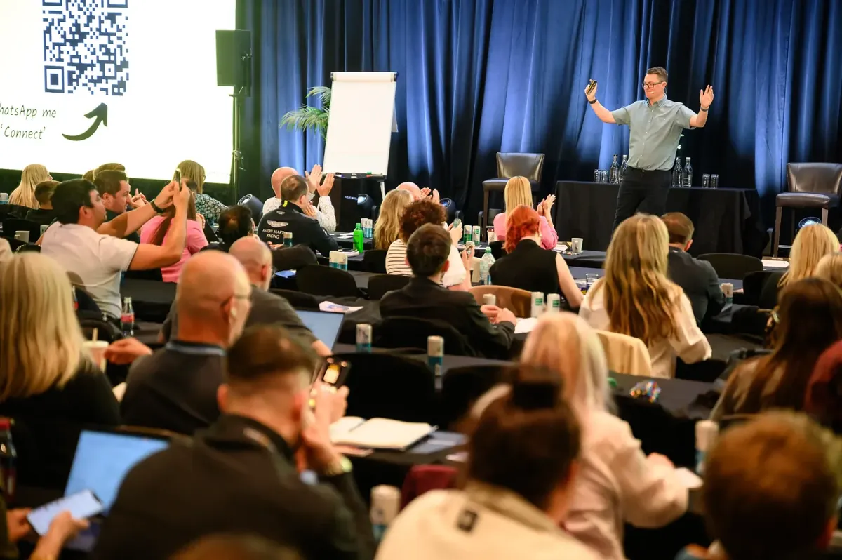 Paul Green speaking to an audience at a live event