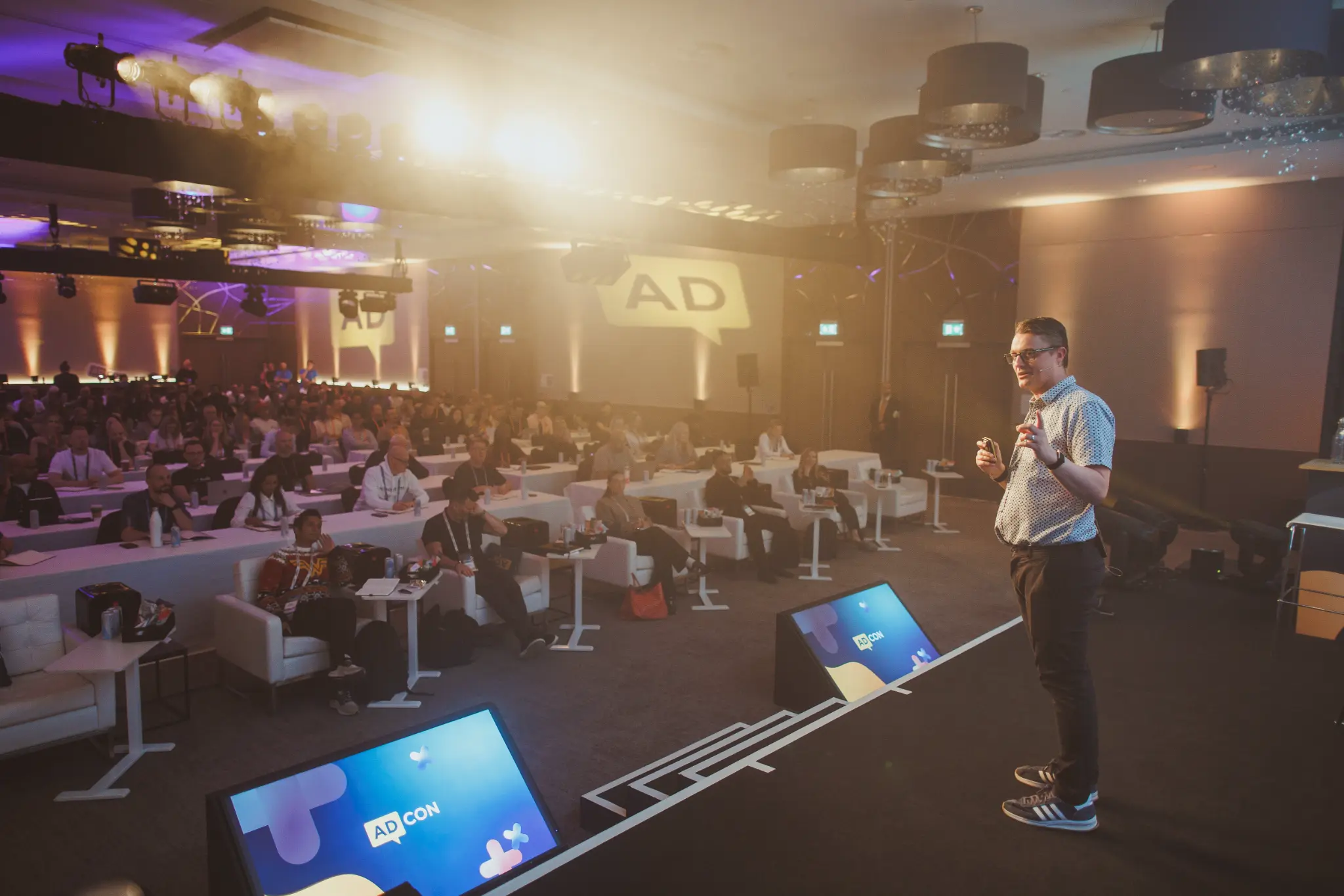 Paul Green speaking on stage at AdCon